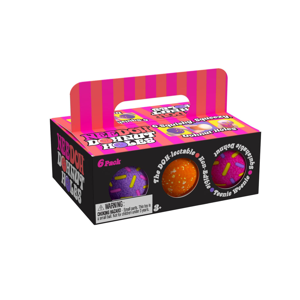 A box of 'NeeDoh Dohnut Holes E6' sensory balls, designed to look like a 6-pack of donut holes. The packaging is black with pink and orange stripes on the handle and top. The front of the box features images of two sensory balls: one purple with pink and yellow sprinkles, and one orange with white sprinkles. The text on the box includes phrases like 'The DOH-lectable', 'Squishable', 'Non-Edible', and 'Teenie Weenie'. There is a warning label indicating the toy is for ages 3 and up due to small parts.